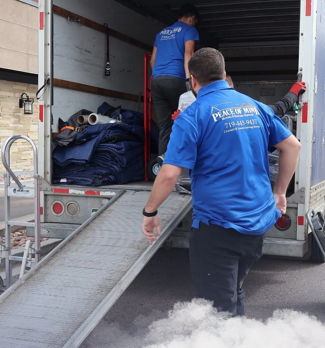 Peace of Mind movers loading a moving truck