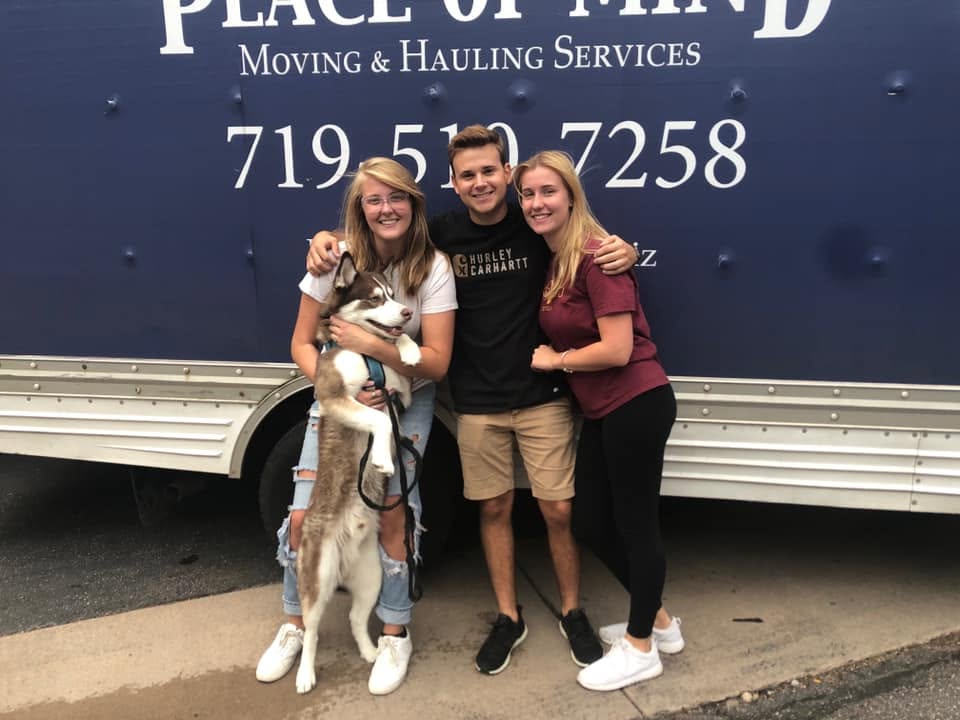 Peace of Mind Moving team members in front of a moving truck